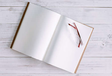 Open book with blank pages on wooden backgroundの写真素材