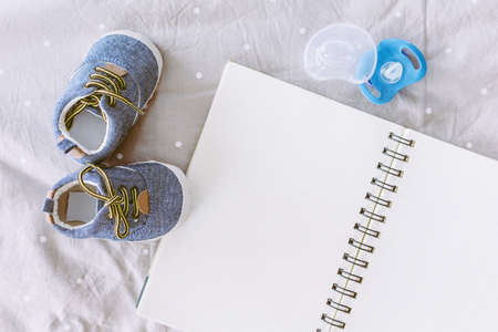 Baby shoes with book  on blanket