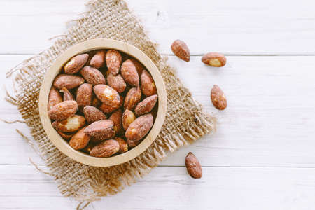 Almonds in bowl on  wooden backgroundの写真素材