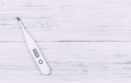 Thermometer on wooden background