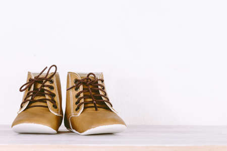 Baby shoes on wooden background