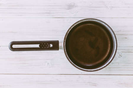 Iron frying pan on wooden backgroundの写真素材