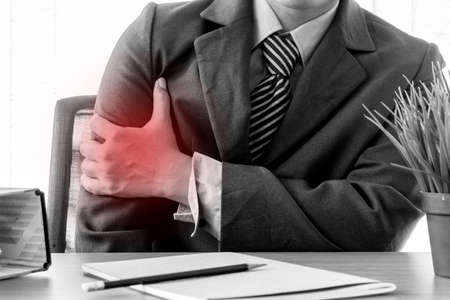 Businessman having shoulder joint problemの写真素材