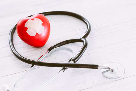 Stethoscope with red heart on wooden backgroundの写真素材