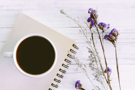 Book with a cup of coffee on wooden backgroundの写真素材