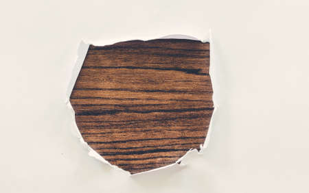 Torn white paper on wooden backgroundの写真素材