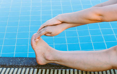 legs of woman relaxing by the poolの写真素材