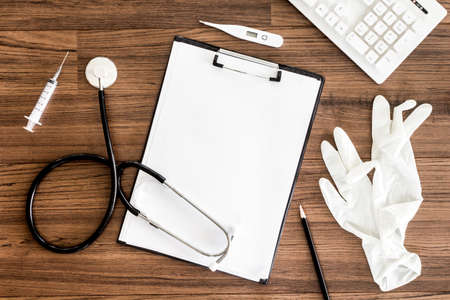 Doctor desk table with stethoscopeの写真素材