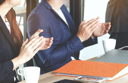 Business people clapping hands in the meeting