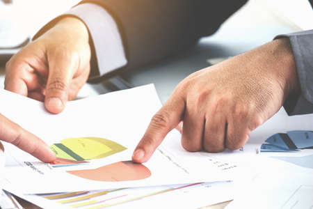 Business hand pointing at business document
