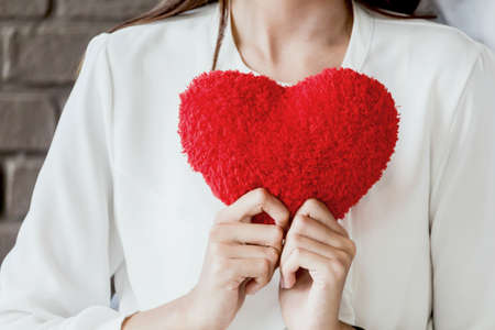 Woman holding red heartの写真素材