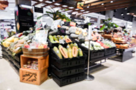 Fruits and vegetables on shelves in supermarket blur backgroundの写真素材