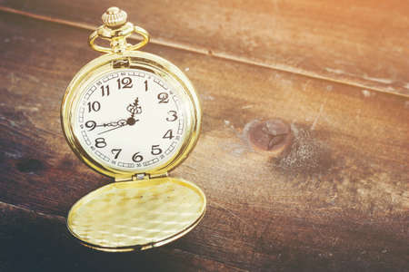 Pocket watch on wooden background の写真素材