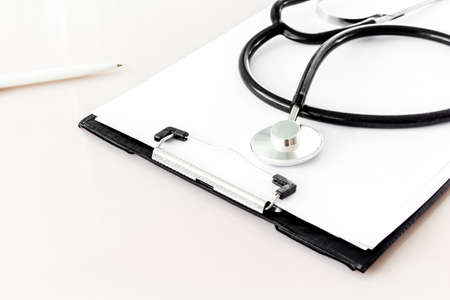 Doctor desk table with stethoscopeの写真素材