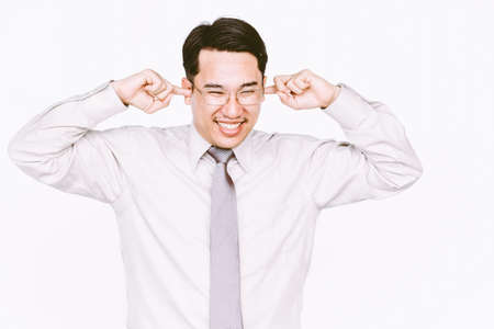 Businessman covering his earsの写真素材