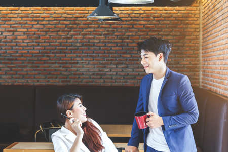 Happy couple drinking coffee at coffee shopの写真素材