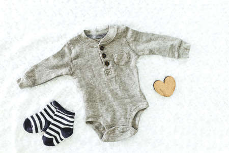 Clothes for baby on the bedの写真素材