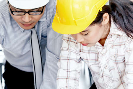 Engineers man and woman construction team on work siteの写真素材