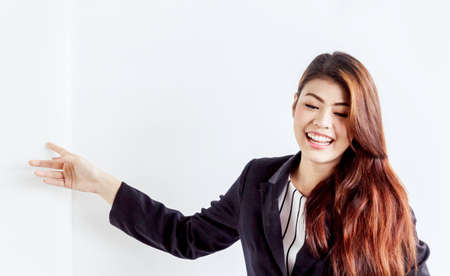 Businesswoman with finger pointing at copy spaceの写真素材