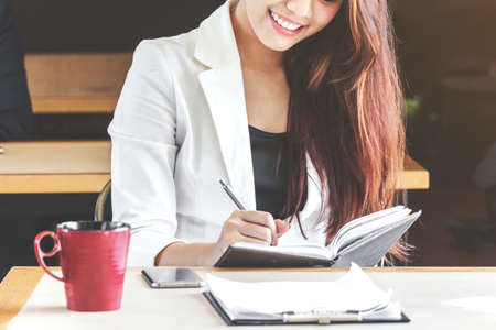 Businesswoman working at a coffee shopの写真素材