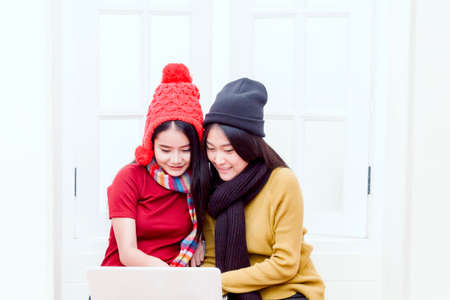 Young female college friends using laptop computerの写真素材