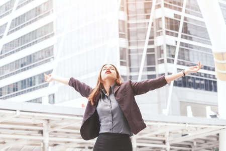 Happy successful business woman with arms opened の写真素材