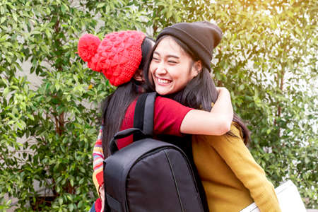 Happy meeting of two woman student huggingの写真素材