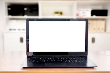 Laptop computer with blank screen on tableの写真素材
