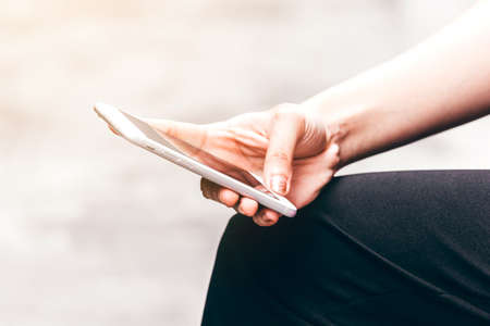 Woman hand using smartphone on the streetの写真素材