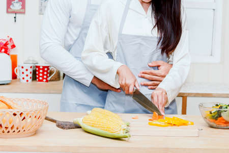 Young couple cooking food in the kitchenの写真素材
