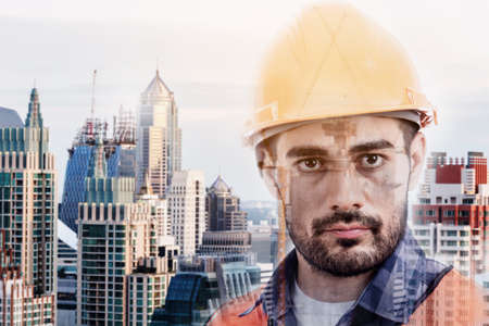 Portrait of an handsome engineer on construction background - Double exposure photoの写真素材