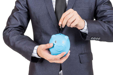 Businessman holding a piggy bank in hands isolated on white backgroundの写真素材