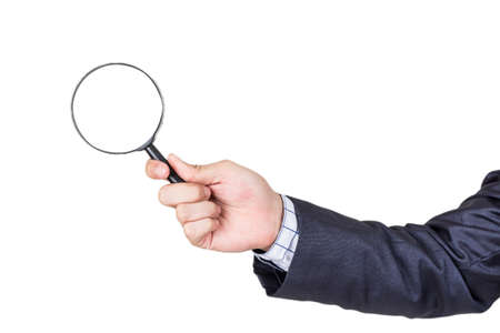 Businessman holding magnifying glass isolated on white backgroundの写真素材