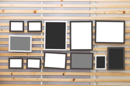 Photo frames on the wooden wall