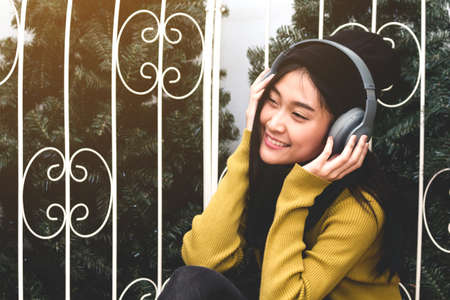 Woman listening music with headphones の写真素材