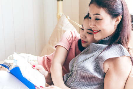 Mother and teen daughter receiving a hugの写真素材