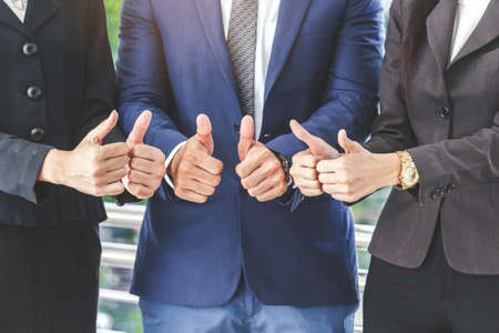 Business teamwork show thumb upの写真素材