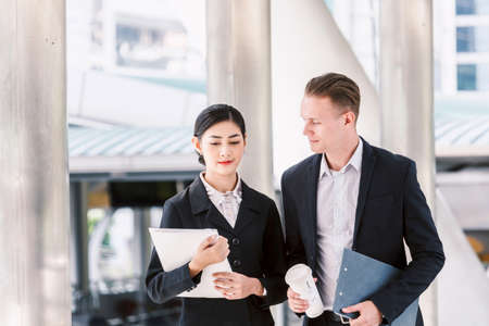 Image two business partners talking and working togetherの写真素材