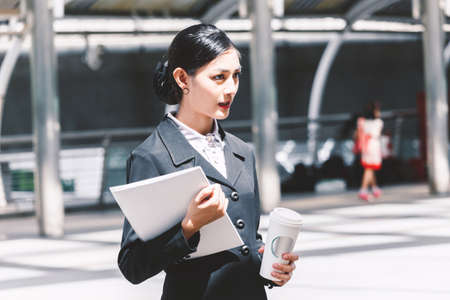 Businesswoman holding a paper coffee cupの写真素材