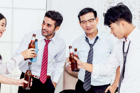 Group of business people professionals successful drink beers in officeの写真素材