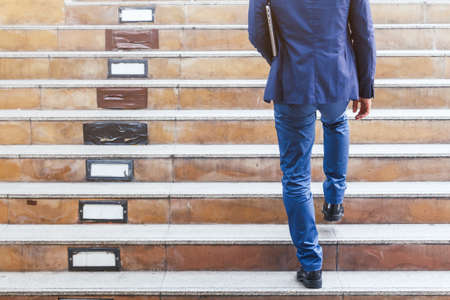 Businessman walking up the stairsの写真素材