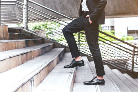 Businessman walking up the stairsの写真素材