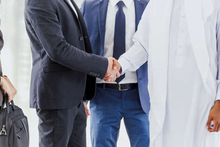 Successful businessmen handshake partner with arab businessmanの写真素材