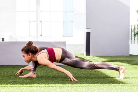 Woman practicing yoga in the park - Healthy lifestyle