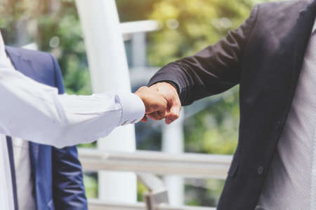 Businessman and partner giving fist bump handの写真素材