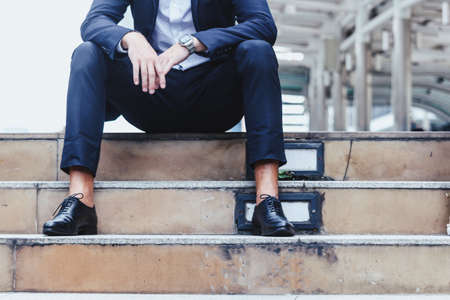 Handsome man  sitting on the stairsの写真素材