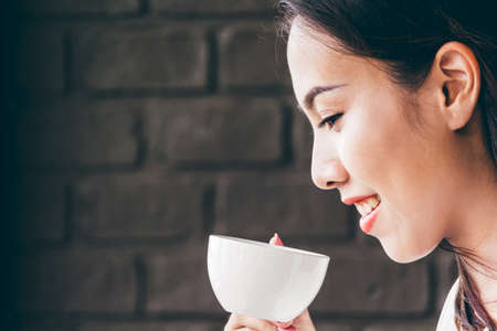 Female drinking coffee in coffee shopの写真素材