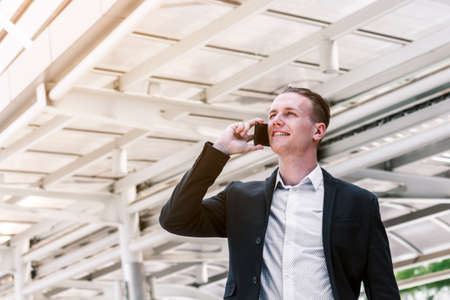 Handsome businessman using his smartphone