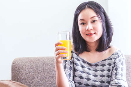 Woman holding glass with tasty juice - Healthy Lifestyle