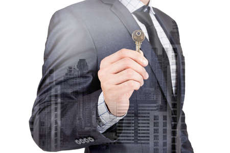 Businessman holding keys isolated on white backgroundの写真素材